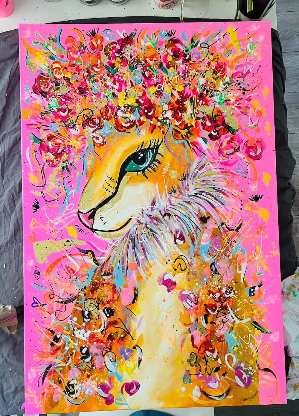 Golden llama with a flower crown on neon pink