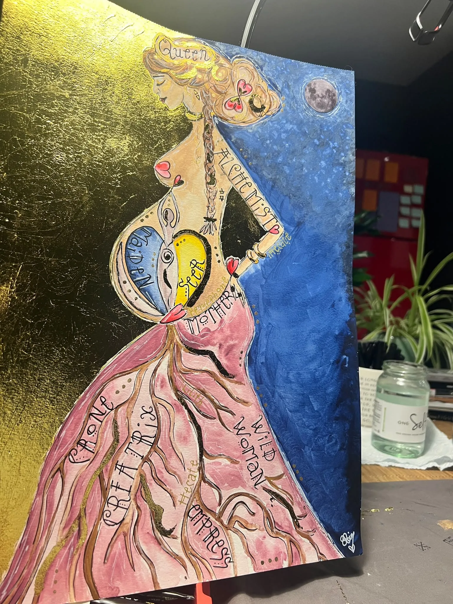 Gold leaf painting of a goddess in a pink gown
