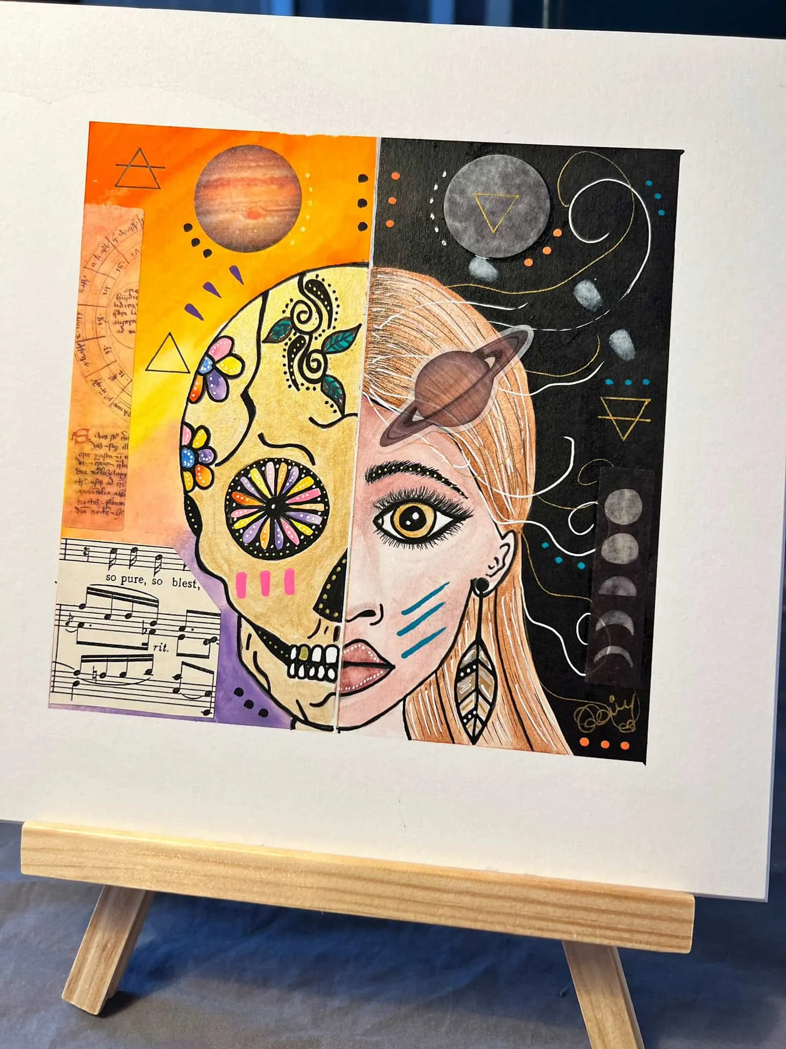 Half skull, half woman collage with planets and sheet music